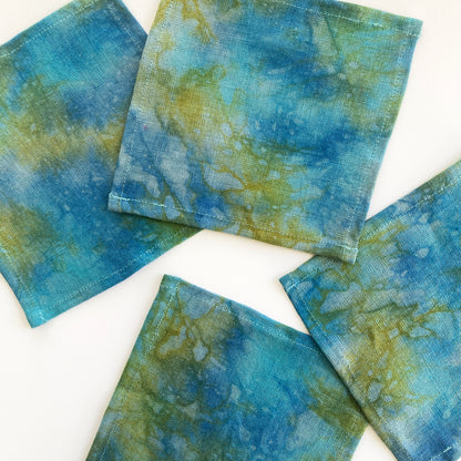 Moonrise green linen cocktail napkins, set of four. Beautifully merging indigo, aqua and gold dyes on linen. Sustainably hand-dyed in small batches and sewn in New York City.