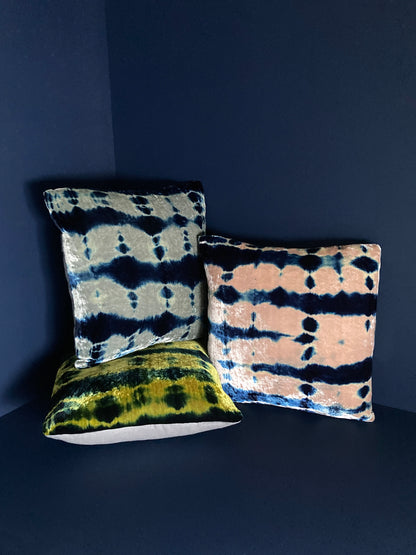 Grouping of gold, pink, silver and indigo velvet pillows in abstract patterns.