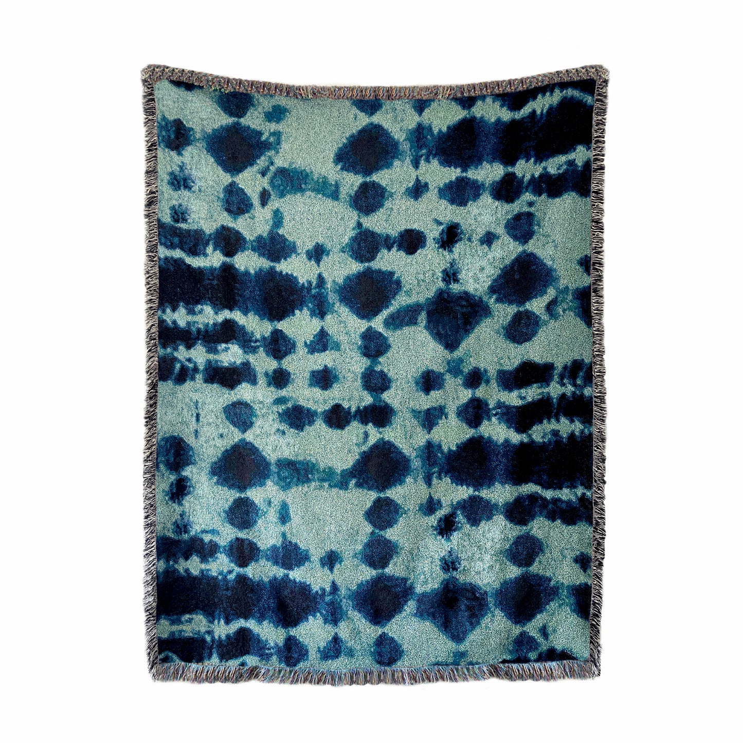 Jade green and indigo blue woven cotton throw blanket with fringed edges, in abstract Inkblot print. 54 by 72 inches.