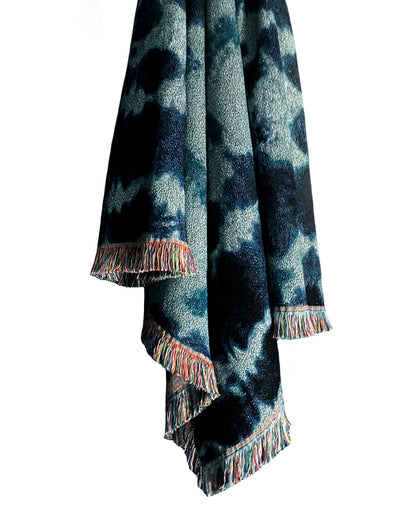 Draped jade green and indigo blue woven cotton throw blanket with fringed edges. 54 by 72 inches. 