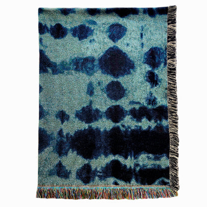 Jade green and indigo blue woven cotton throw blanket with fringed edges. 54 by 2 inches.