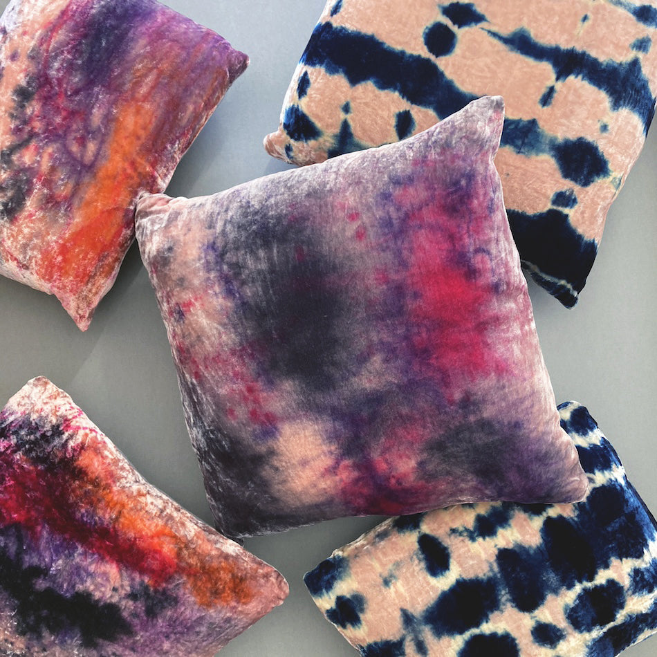 Grouping of rose pink velvet pillows in abstract patterns.