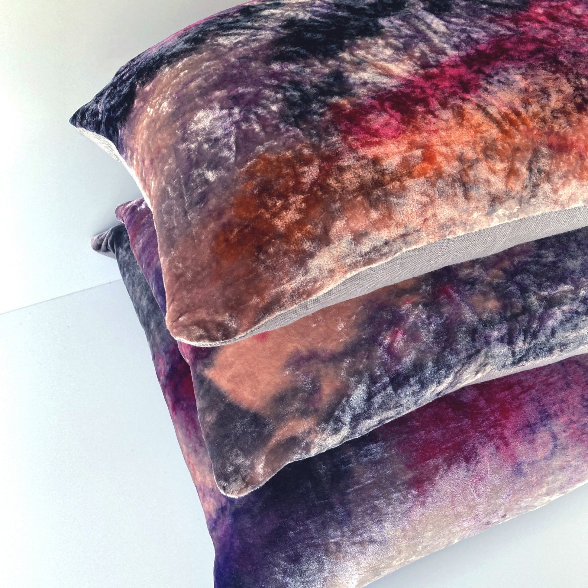 Grouping of rose pink velvet pillows in abstract patterns. Hand painted.