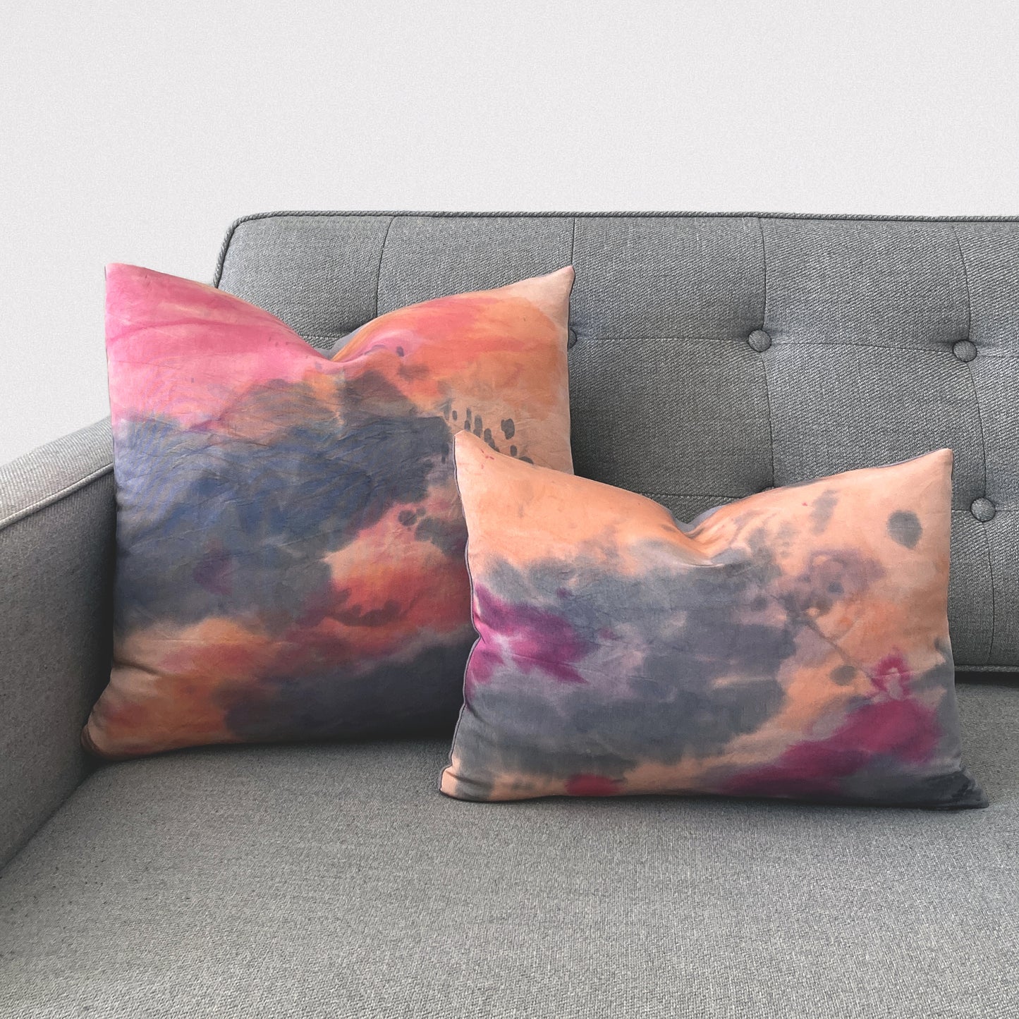 Grouping of rose pink silk pillows in abstract patterns.