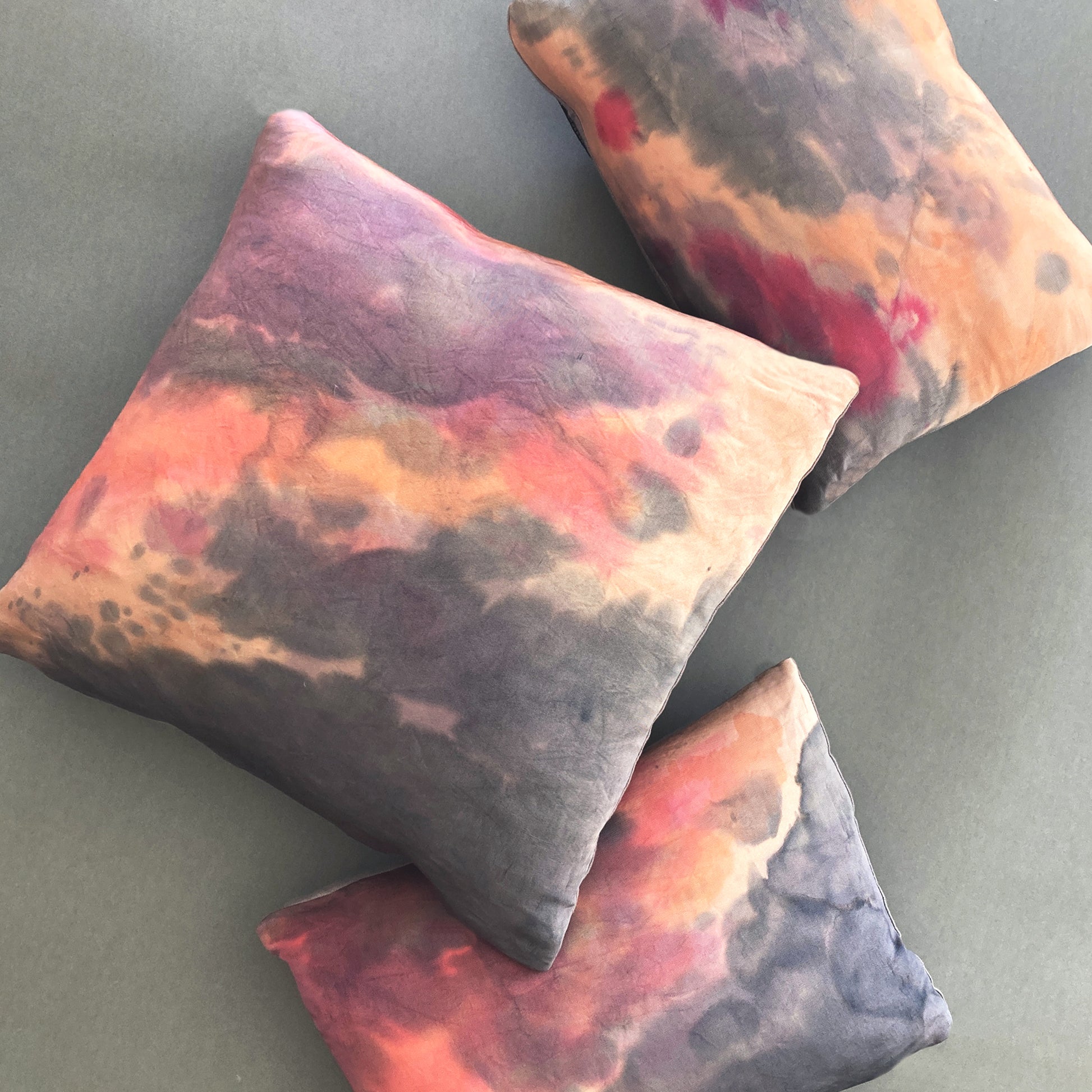 Grouping of rose pink silk pillows in abstract patterns. Hand painted.