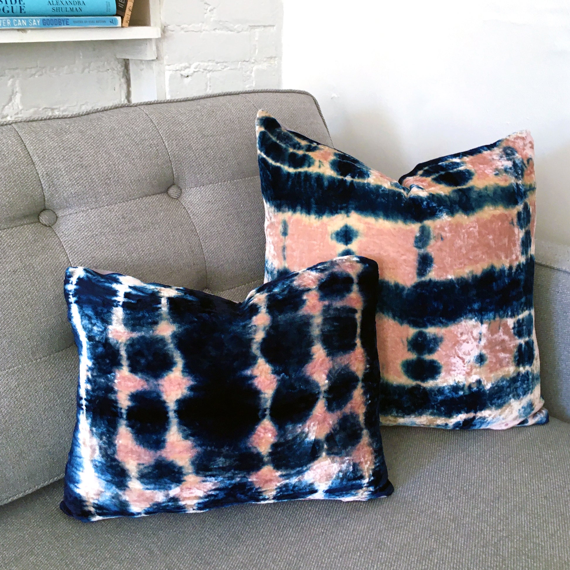 Grouping of rose and indigo velvet pillows in abstract patterns.